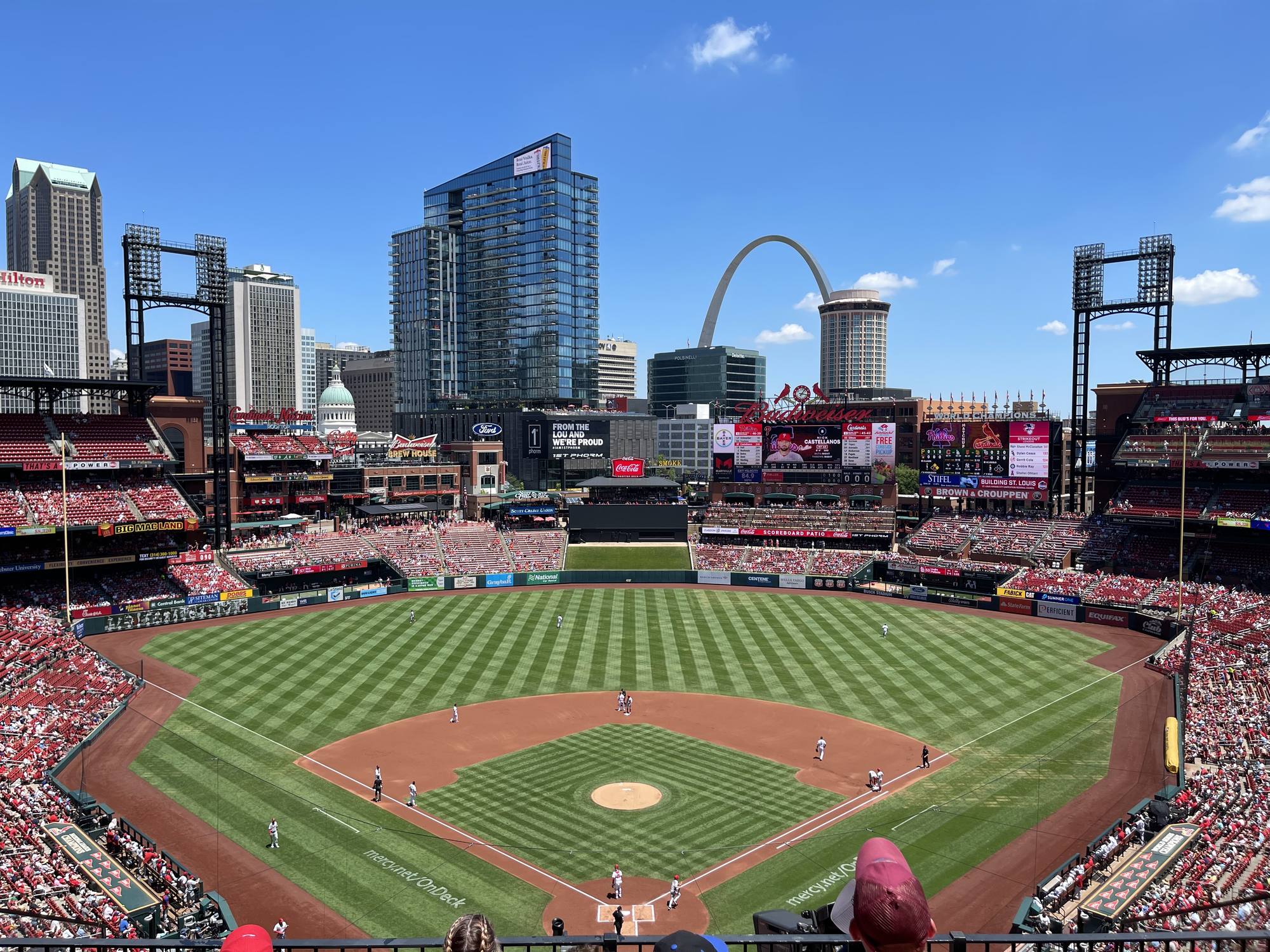 Busch Stadium bowl from the upper deck with the Gateway Arch and the St. Louis skyline framed over right-center field
