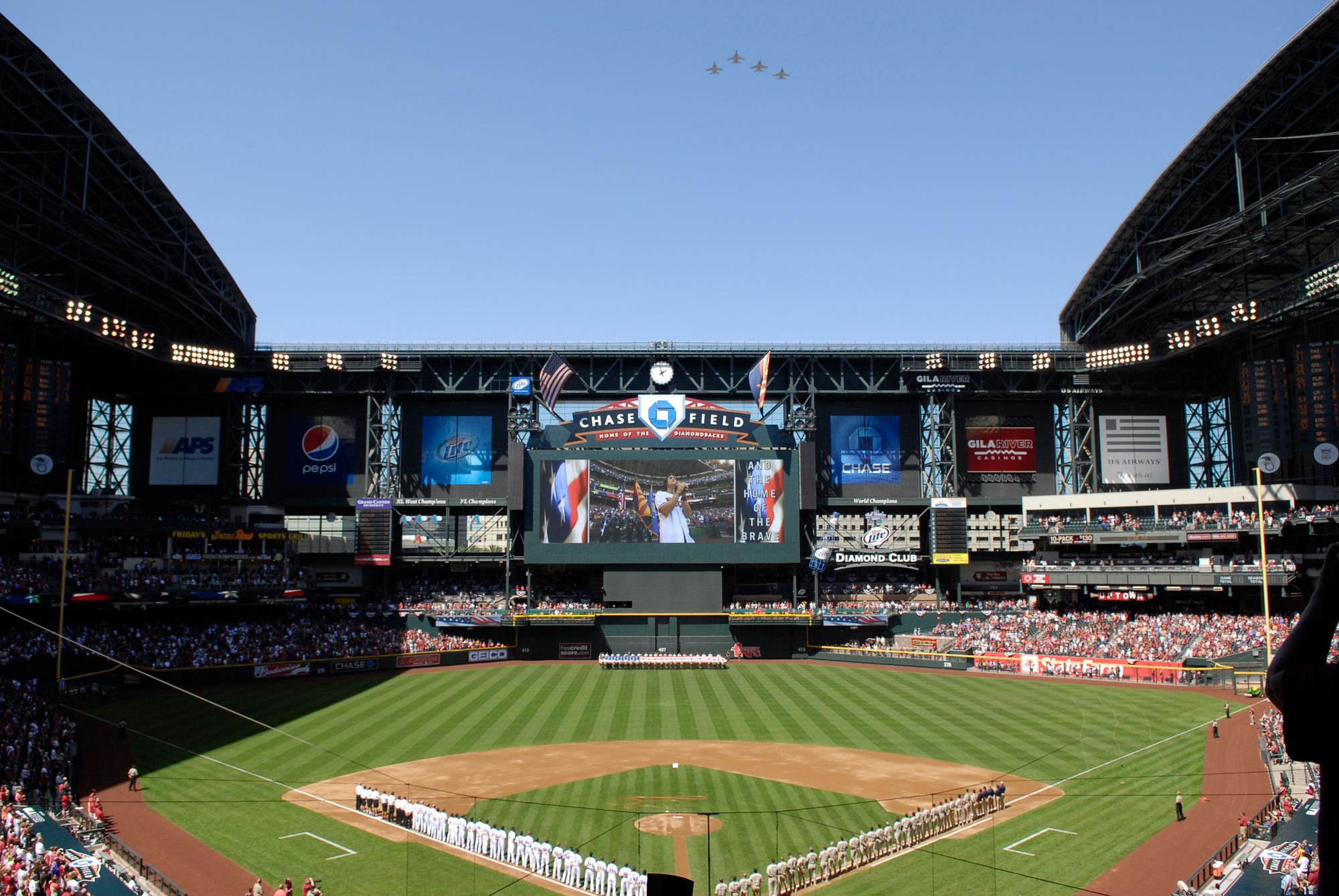 Military jets flying over Chase Field with the roof open on Opening Day