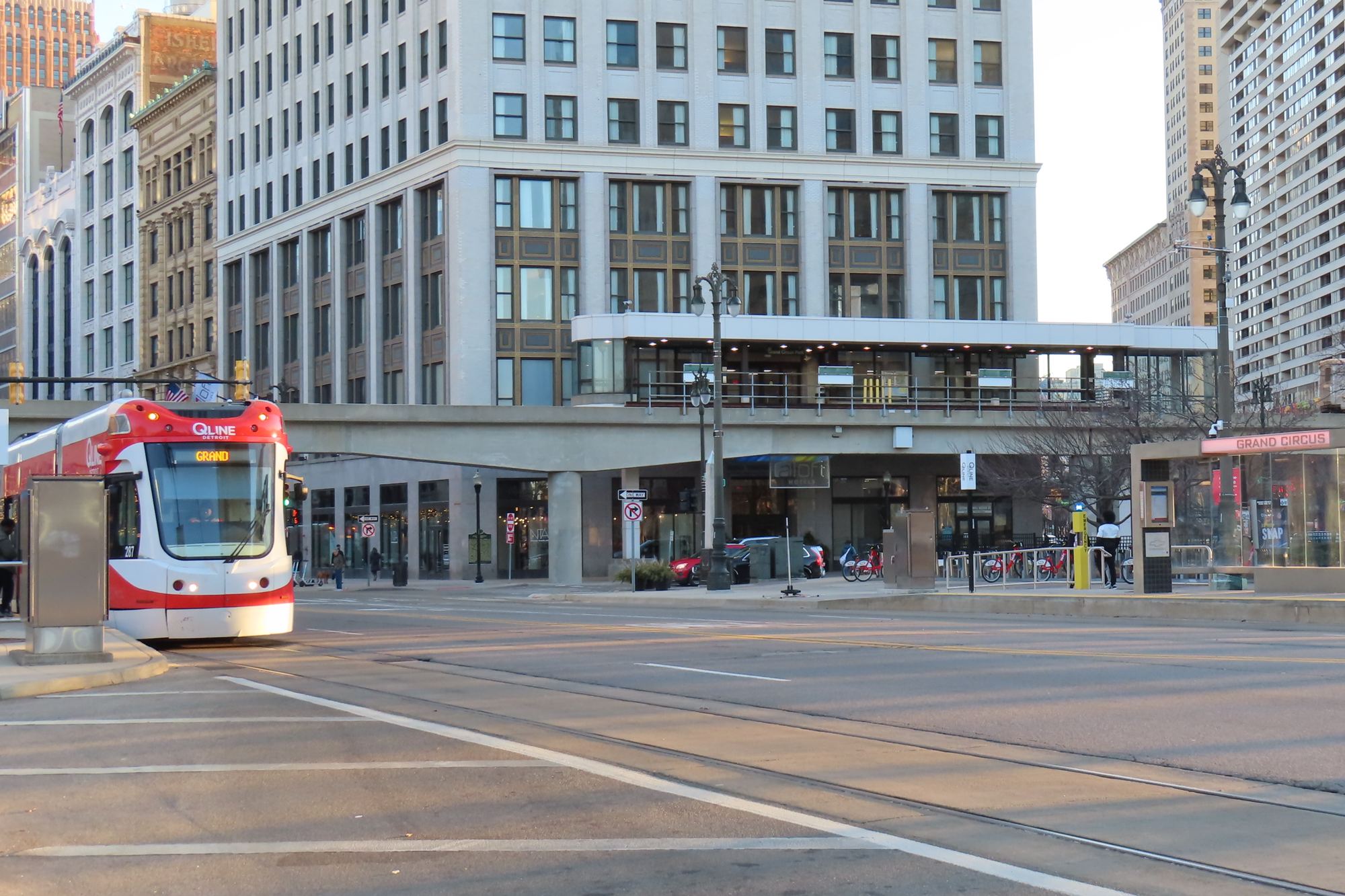 A QLine streetcar at the Grand Circus Park station in downtown Detroit, the People Mover track overhead