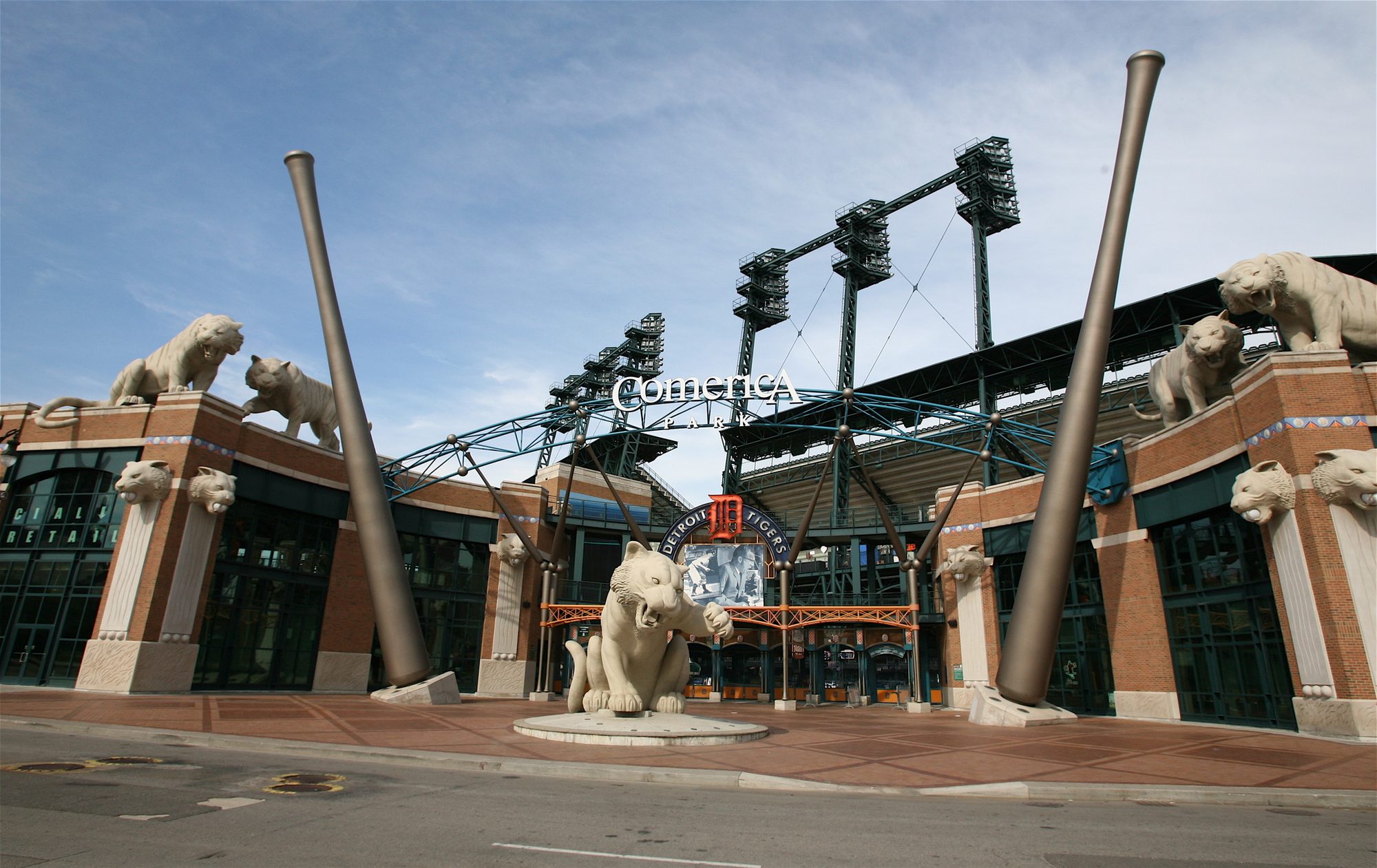 The west entrance of Comerica Park in Detroit, with the tiger statues flanking the gate and the bat-shaped light poles above