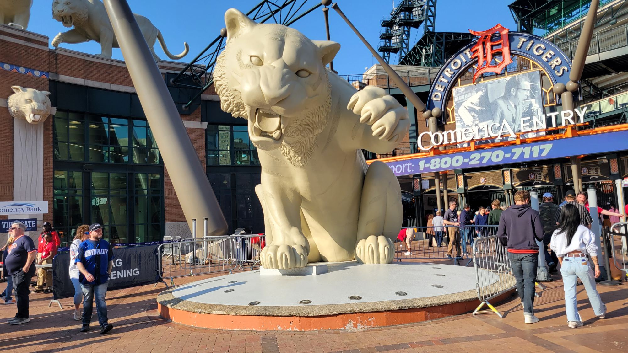 The giant tiger statue outside the Comerica Park entrance, with fans walking past