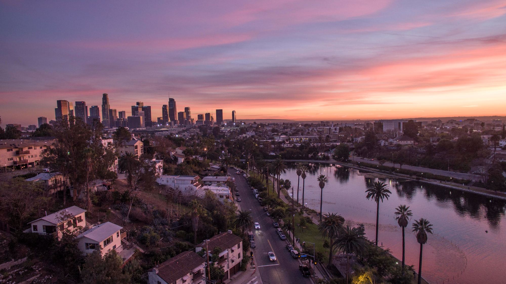 Echo Park Lake at dusk, with the downtown Los Angeles skyline behind it