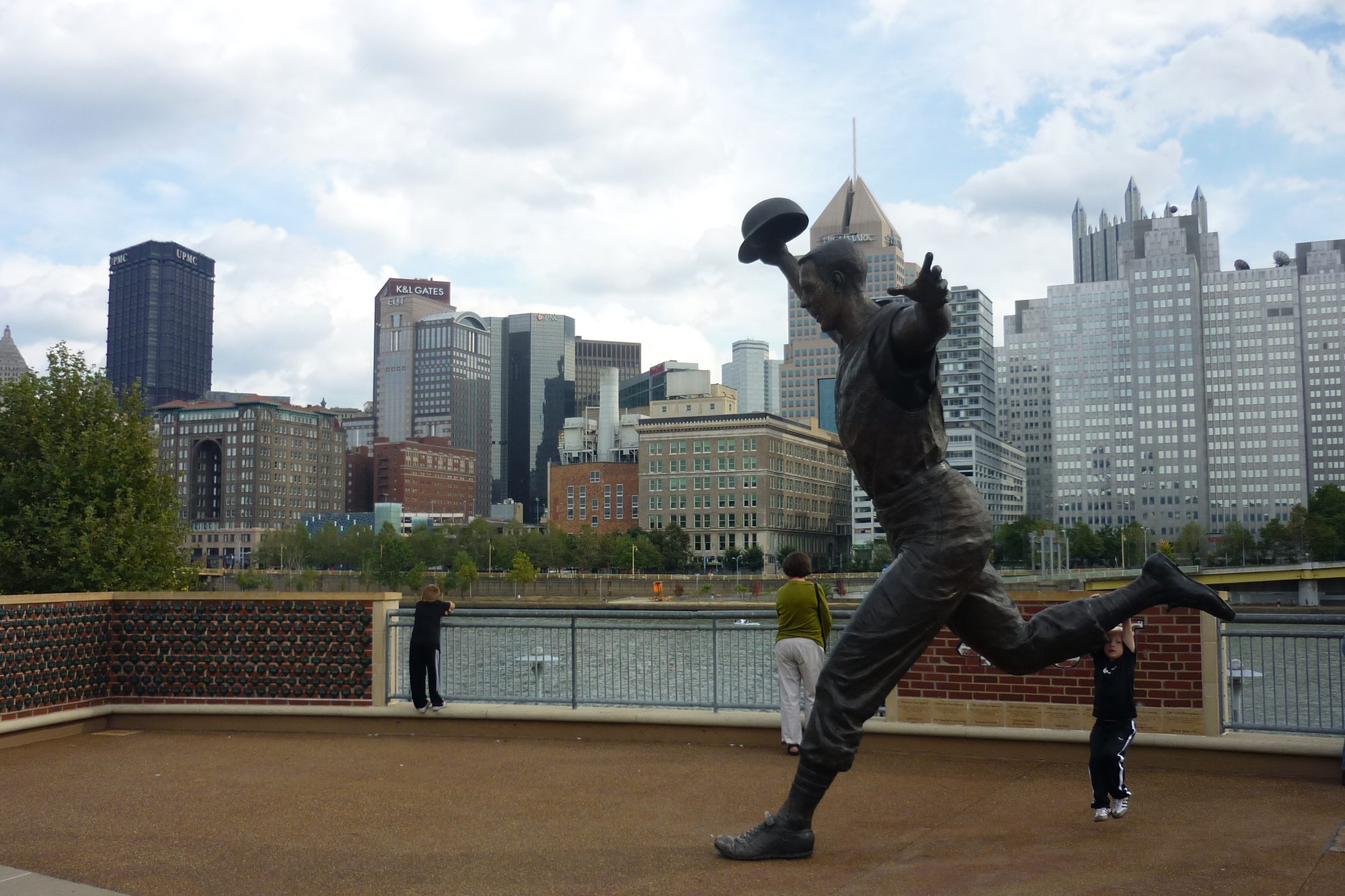 The Bill Mazeroski statue outside PNC Park, the downtown Pittsburgh skyline behind it
