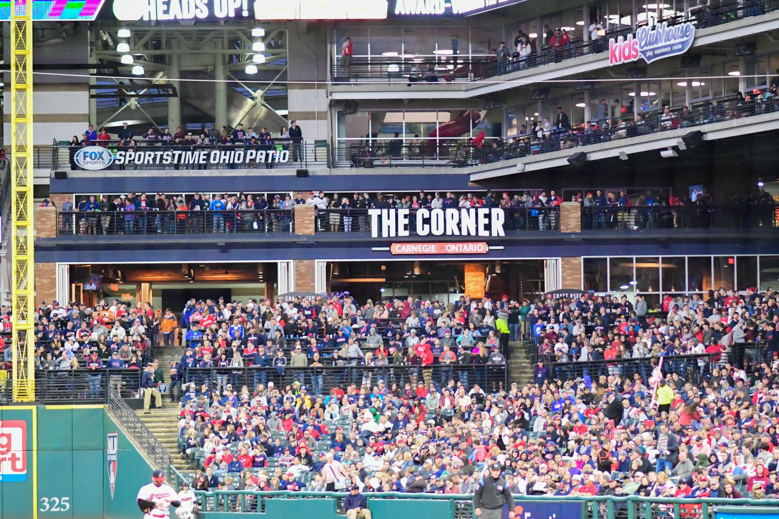 The Corner, the two-level bar and patio deck in right field at Progressive Field, fans lining both levels above a packed section of seats