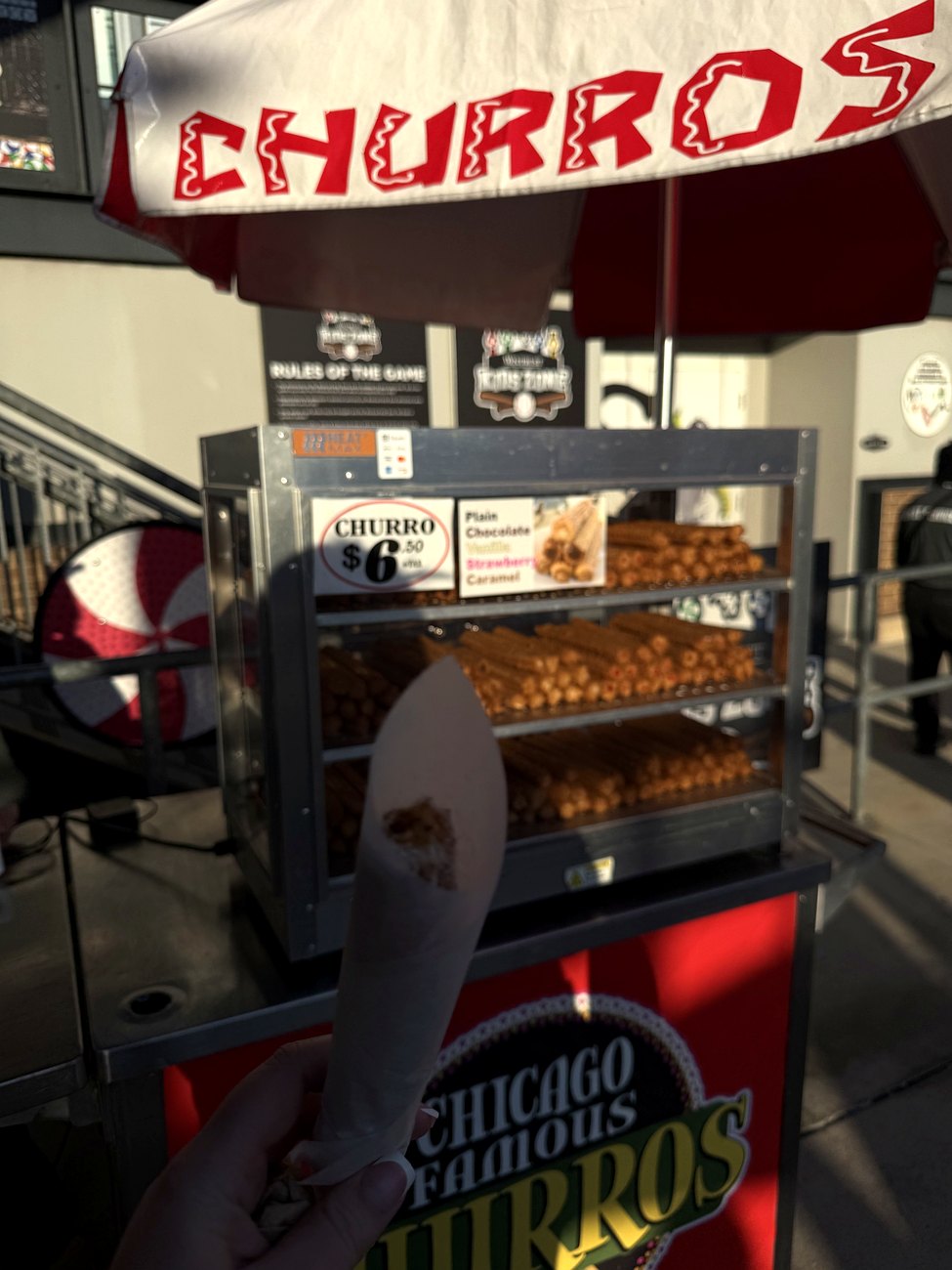 A churro held in hand at the Rate Field churro cart