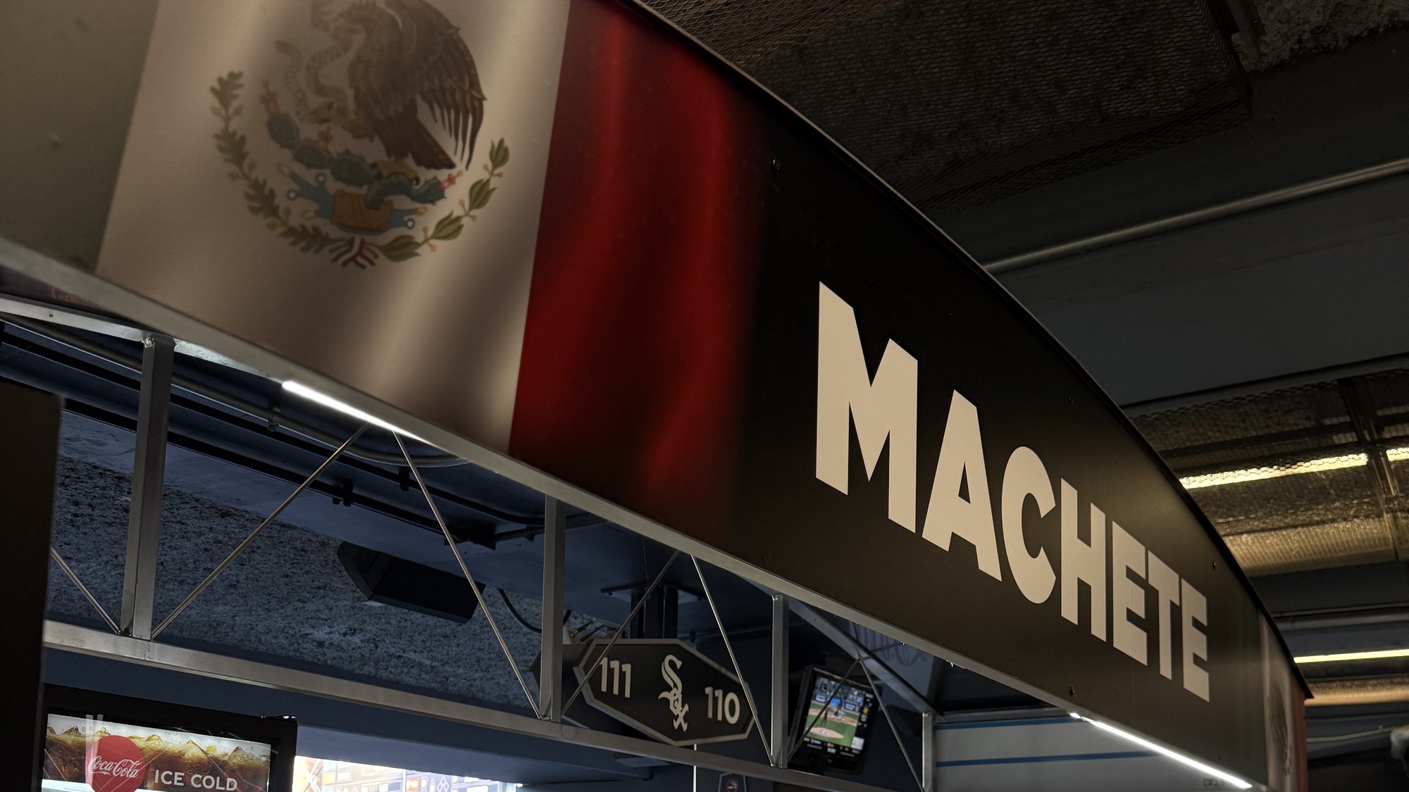 The Machete stand under a Mexican-flag banner at Sections 110 and 111 on the Rate Field main concourse