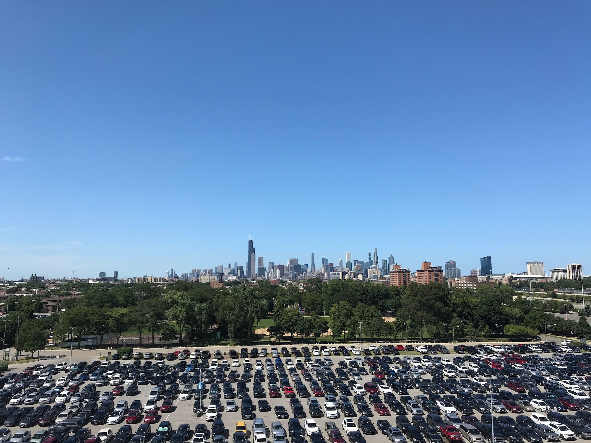 The surface parking lots next to Rate Field, with the Chicago skyline in the distance