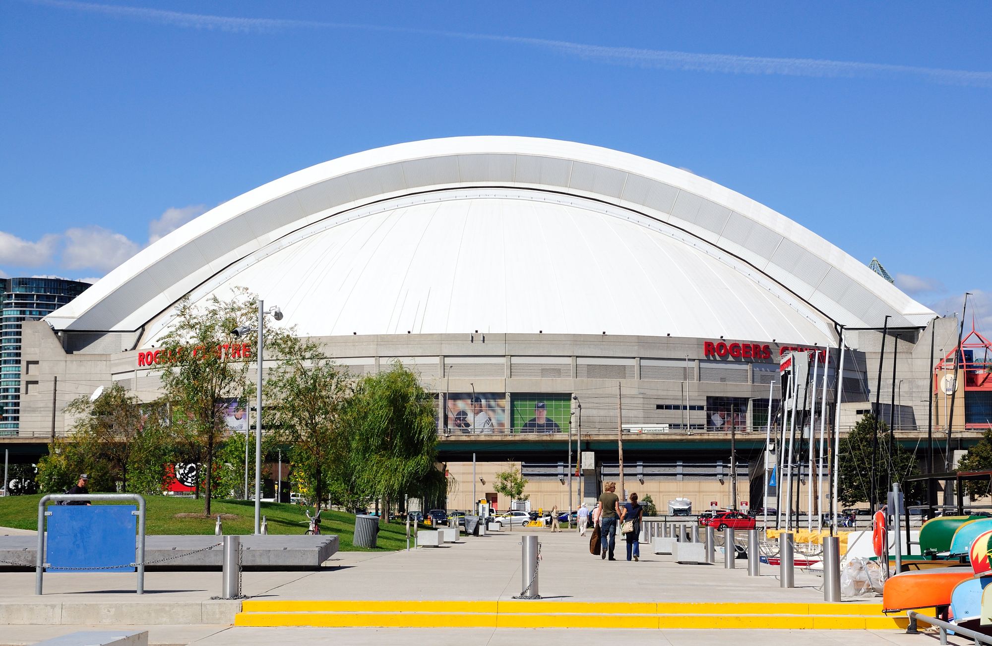 The exterior of Rogers Centre in downtown Toronto, its white domed roof above the entrance plaza