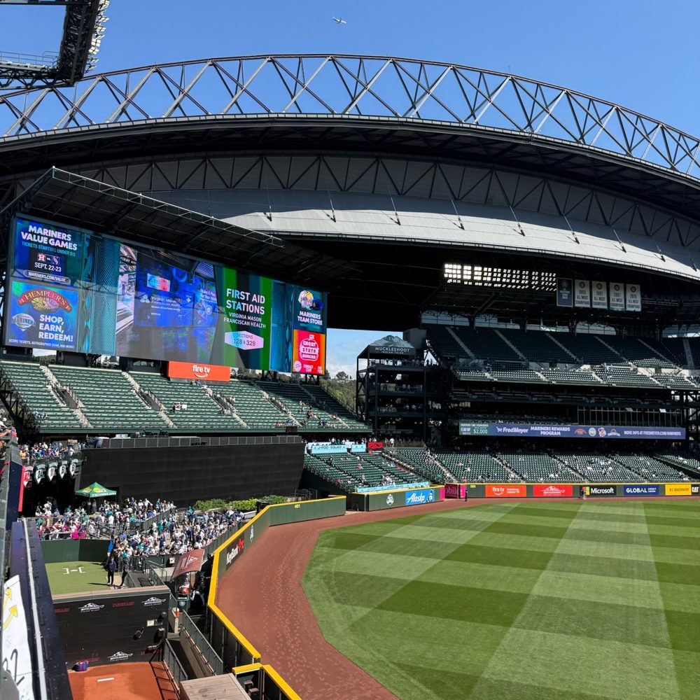 The upper outfield seats at T-Mobile Park, with the retractable roof parked in its open position above right field under a clear sky