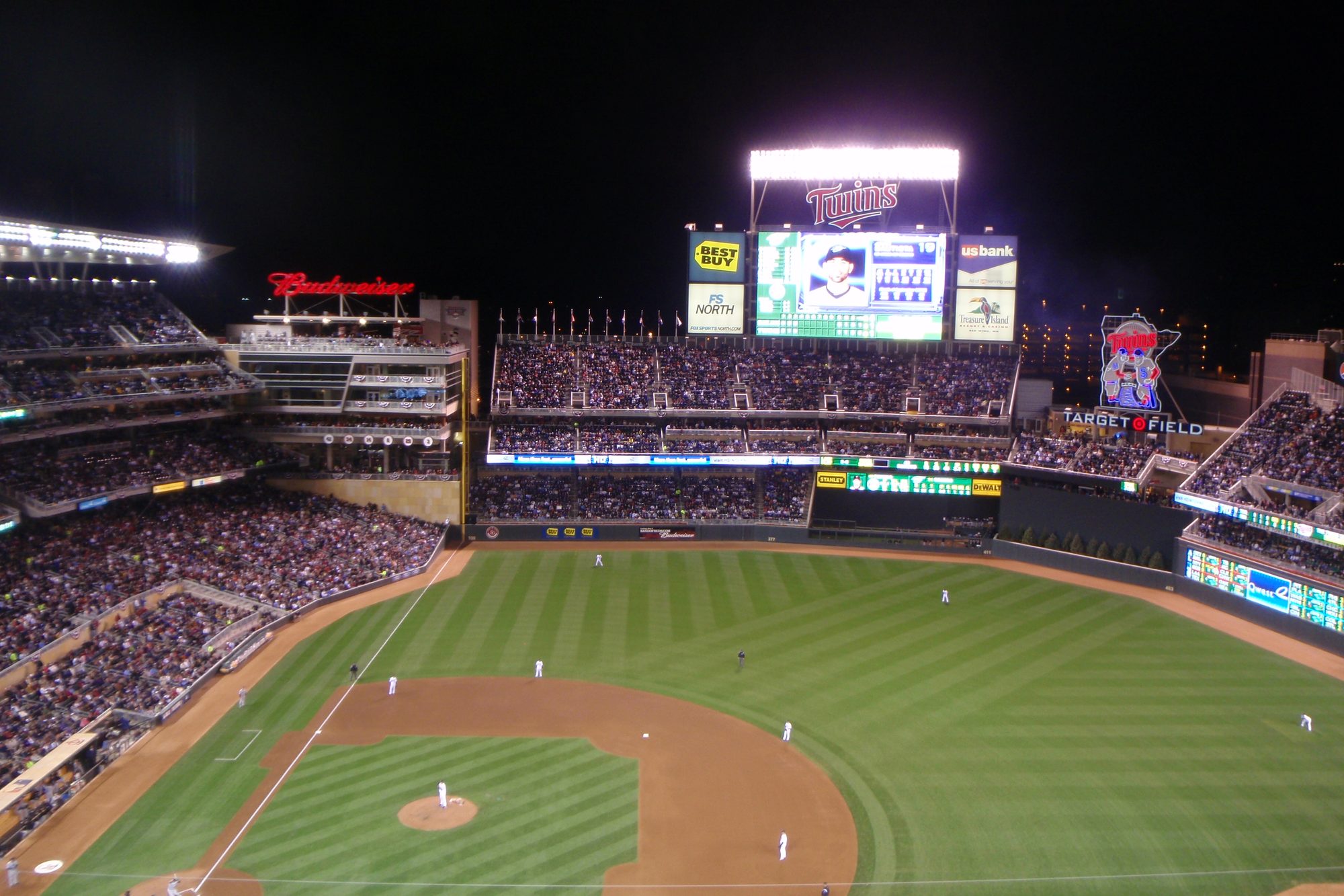 A night game at Target Field, the bowl full and the lights on over the field