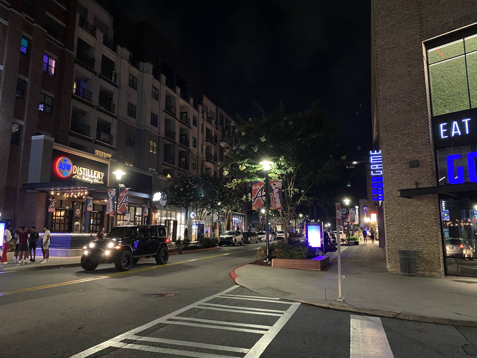 The Battery Atlanta entertainment district lit up at night beside Truist Park