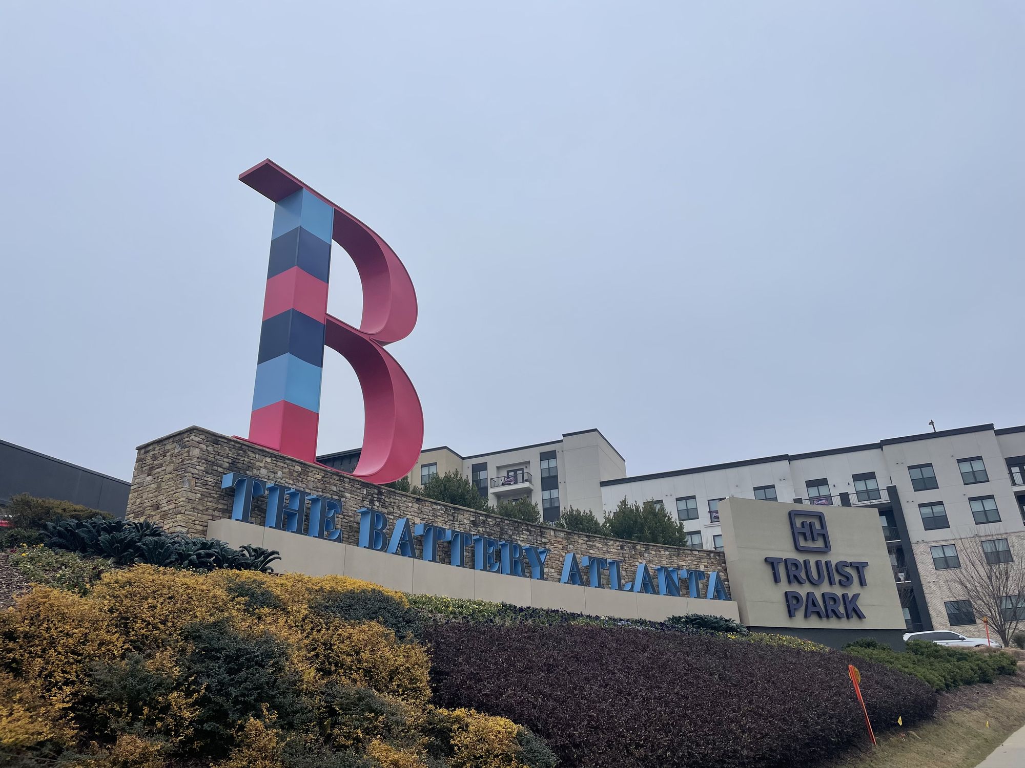 The Battery Atlanta sign with the Truist Park panel at the entrance to the ballpark district